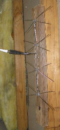 Antenna with centered balun, hanging in attic.